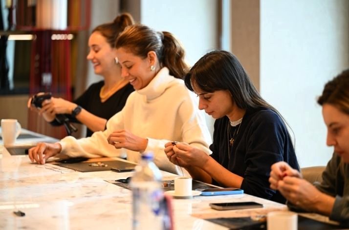 Girls spending enjoyable time during an intimate natural stone bracelet workshop.