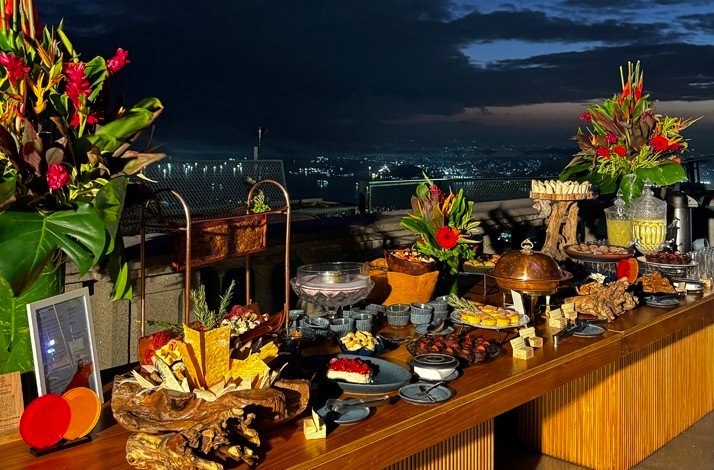 Table full of food served during a special breakfast with a panoramic view of the city