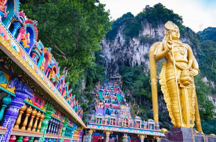Vibrant and colorful stairway to Batu Caves with Statue of Murugan