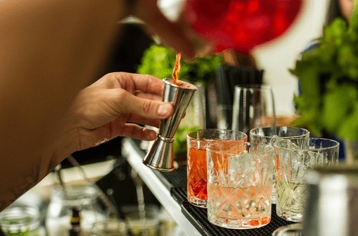 A person mixing a cocktail during the private tour