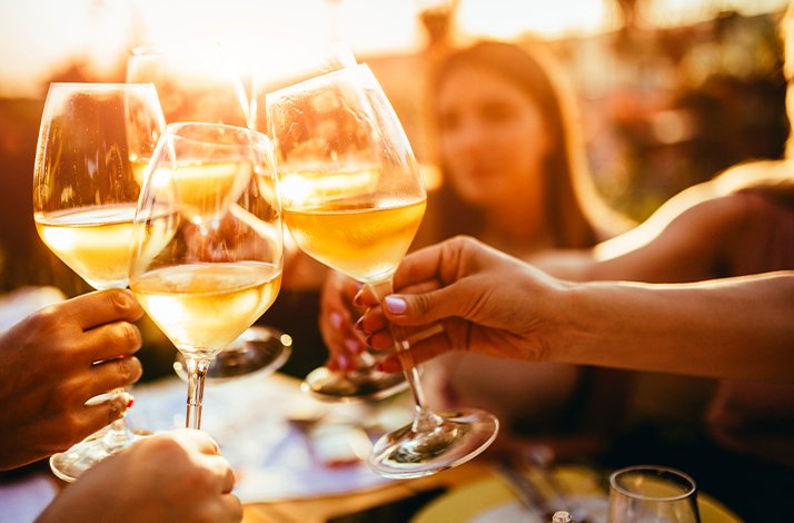 People cheering with their aperitifs in an enoteca.