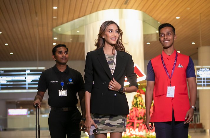 The woman receives a warm reception from a dedicated officer.