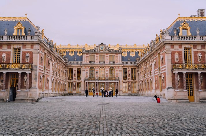 The Palace of Versailles is a former royal residence commissioned by King Louis XIV located in Versailles.