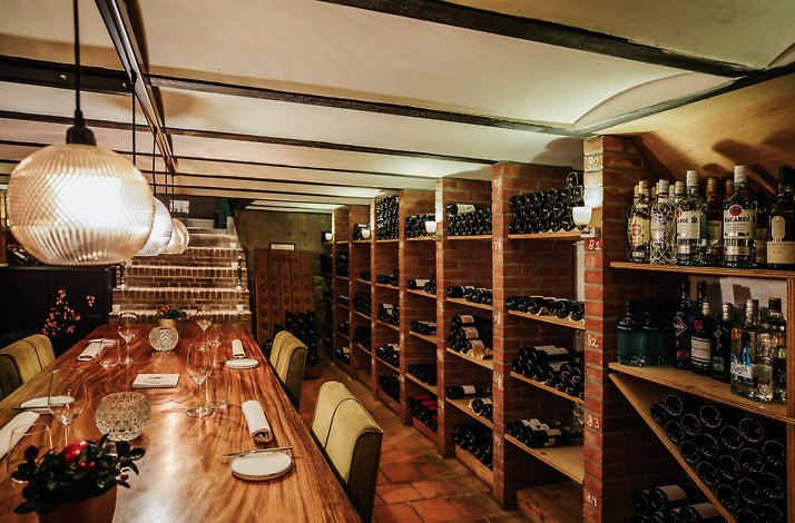 A dining room with wine shelves at Restaurant, Hotel & Spa Savarin