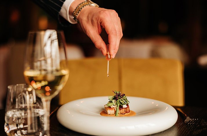 A plate of fresh meal and a glass of white wine