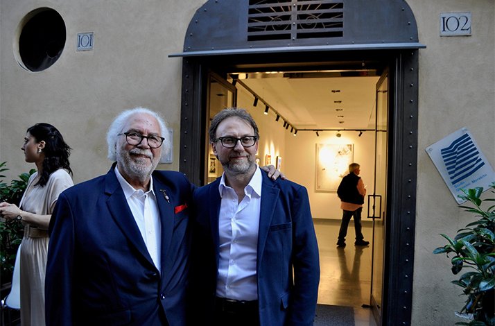 Artists posing for a photo next to monogramma art gallery in Via Margutta.