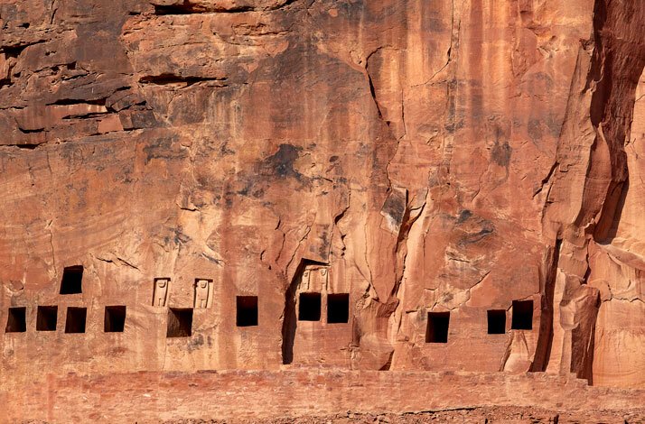 A close-up view of ancient petroglyphs carved into rock, showcasing intricate designs and symbols from a historical culture in Saudi Arabia.