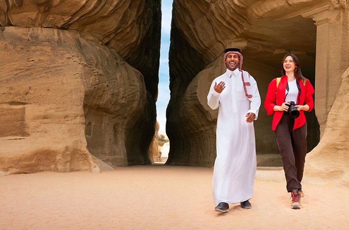 Abdulaziz Albalawi, a native Saudi storyteller showing a woman Hegra during the day light.