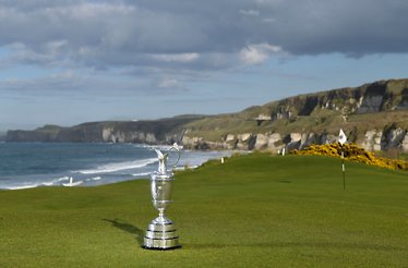 The golf cup standing on the golf field next to coast