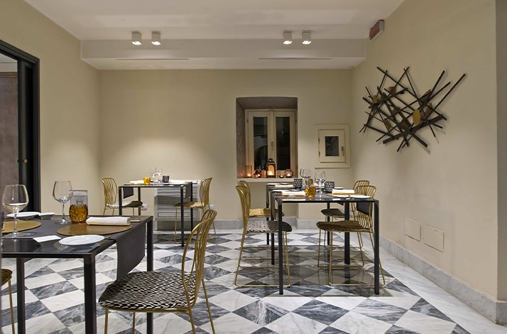 A restaurant interior featuring black and white checkered flooring, creating a classic and inviting atmosphere for diners.
