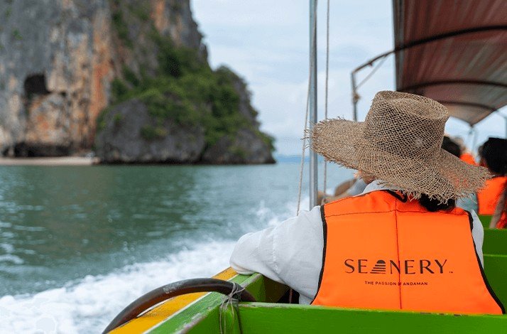 A woman in a hat enjoys a scenic boat ride organized by Seanery tour operator