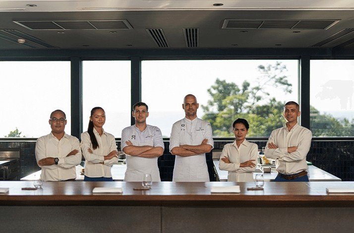 The kitchen staff of restaurant PRU wearing white uniforms