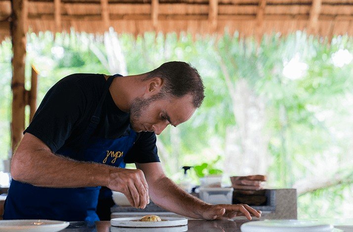 A chef finishing cooking his special dish.