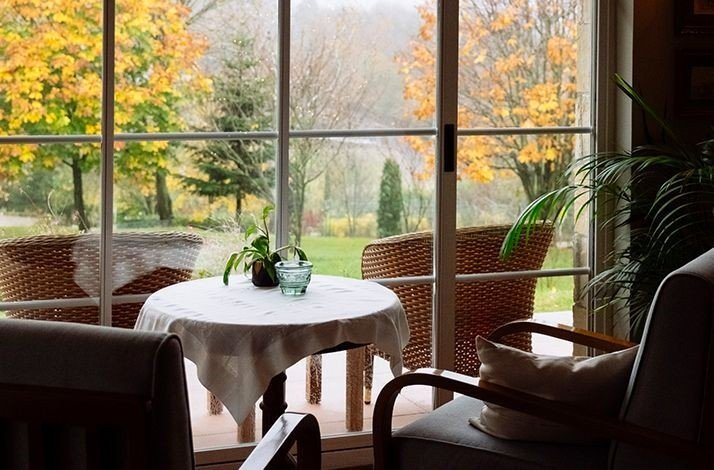 A cozy table by the window overlooking nature at Casa Lavanda.