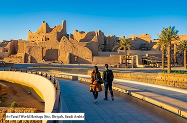 A couple walking towards At-Turaif World Heritage Site, Diriyah, Saudi Arabia.
