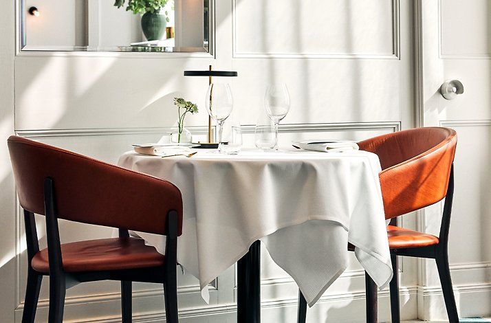 Receive special treatment at Michelin-star Seafood Gastro: In Stockholm, Sweden Set table with tablecloth and two chairs Restaurant Seafood Gastro.