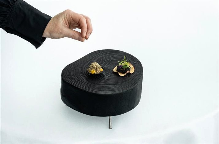 Enter PM & Vänner's wine vault for a one-of-a-kind tasting experience: In Växjö, Sweden A hand of the chef decorating a haute cuisine dish served in PM & Vänner restaurant, home to a world-class wine collection and award-winning sustainable dining