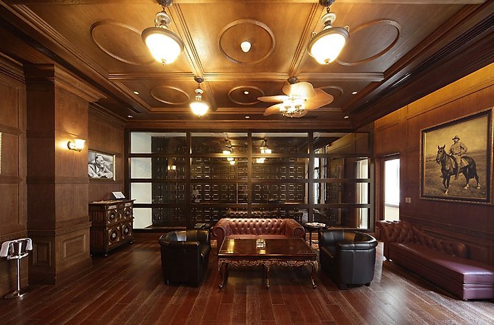 Access the prestigious Roosevelt Club Floor for a luxe dining experience: In Shanghai, Mainland China One of the halls at the House of Roosevelt with leather sofas and armchairs, wooden floor, ceiling and walls.