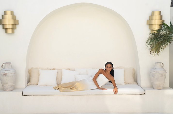 Charlotta Gandolfo posing for a photo in a white-and-gold dress.