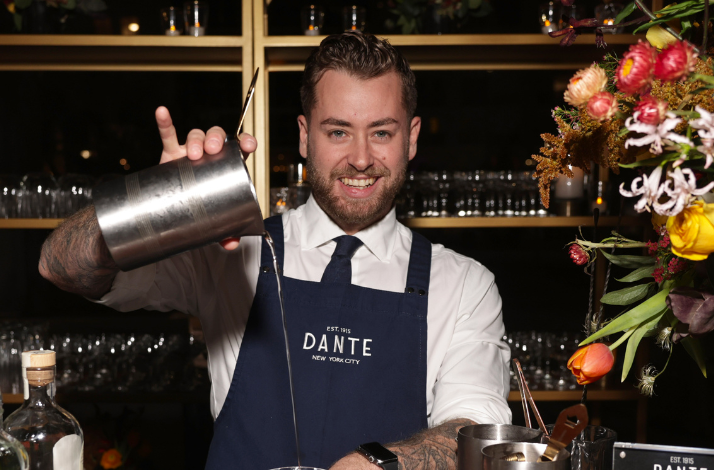 A bartender pouring a cocktail at Dante NYC.
