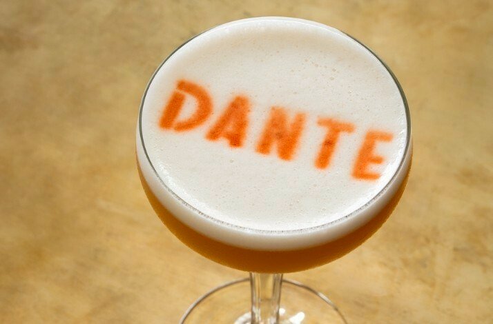 Foam art of DANTE written on a cocktail
