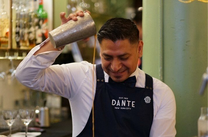 A bartender making a specialty cocktail at Caffe Dante