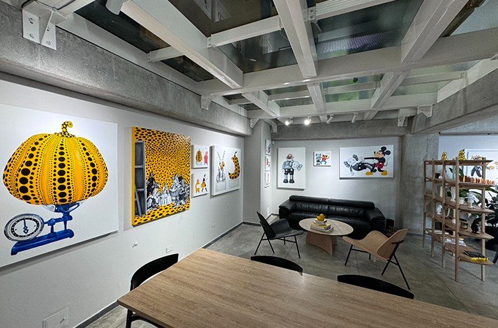 Sofa and table among bright paintings at Zehn Living.