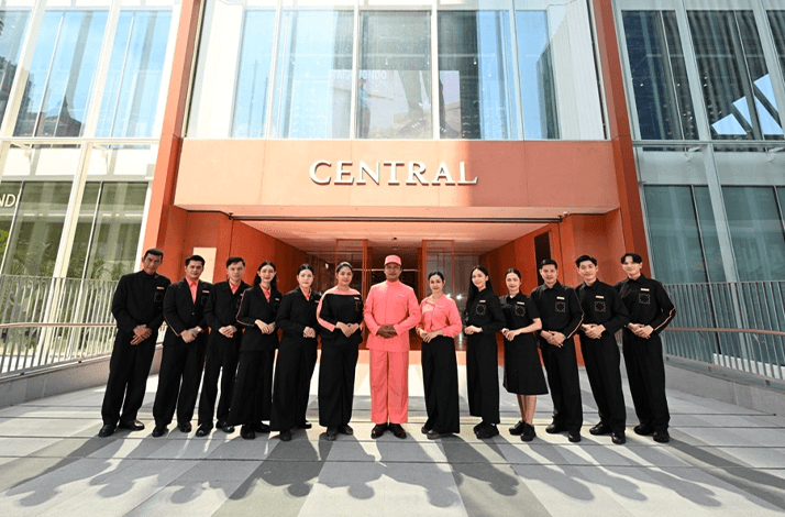 Central Chidlom staff posing in front of Central Chidlom store entrance.