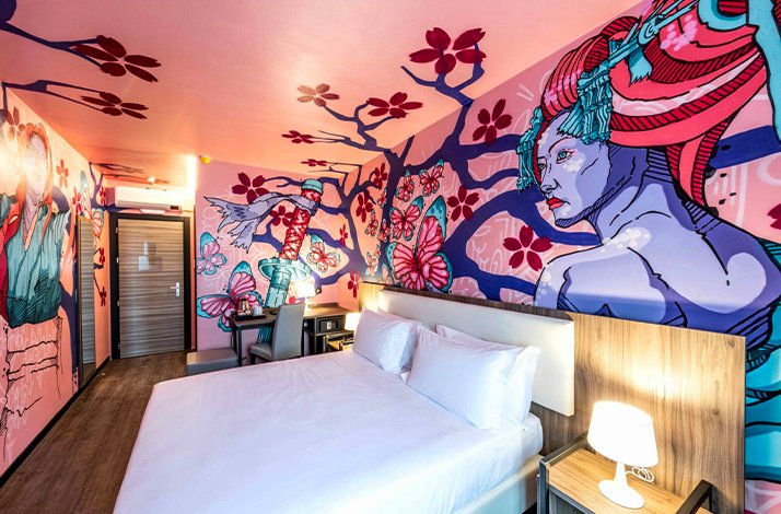 A hotel room with a large bed and japanese themed wall art