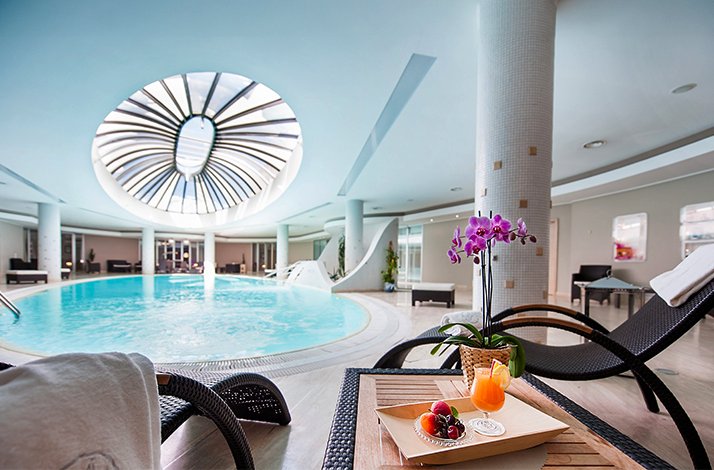 A luxurious indoor pool with natural lighting