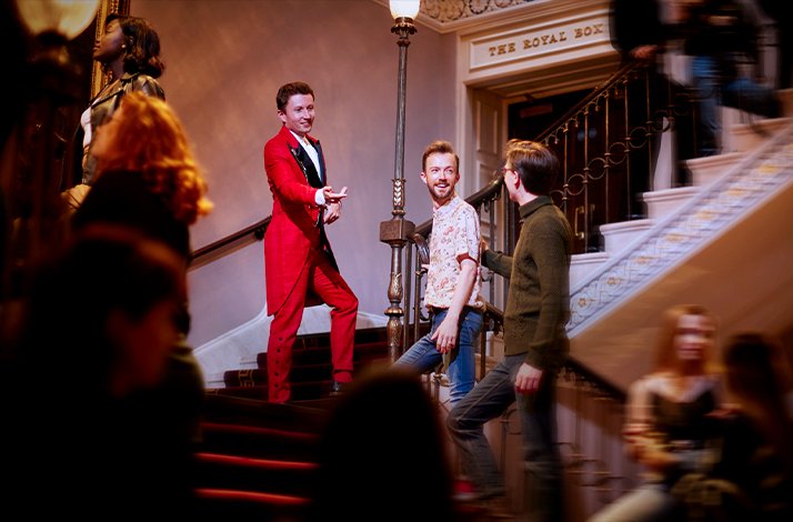 Guests following Red Coat concierge upstairs at LW Theatres.