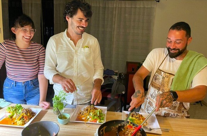 Three people enjoying a home cooking class at Yeira`s home.