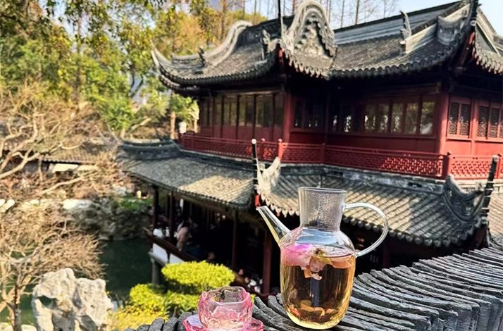 Yixing pot streaming on the background of a building from City God Temple in Shanghai.