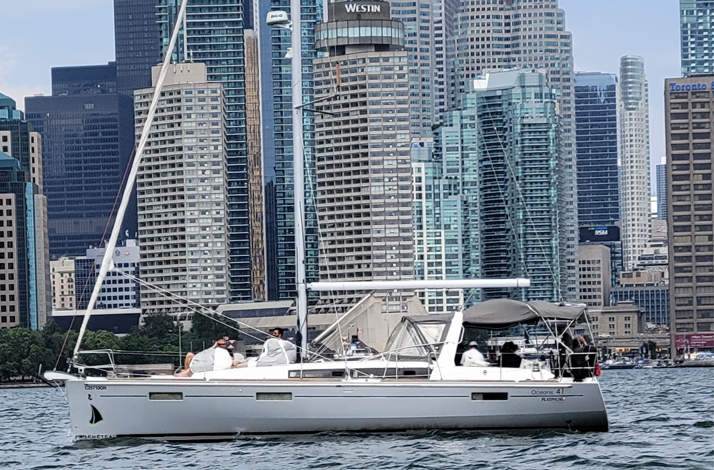 A luxury sailing yacht cruising along Toronto Harbour.