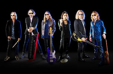 Promotional banner for Foreigner, displaying the band members.