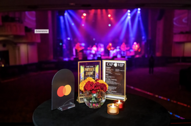 A table with a Mastercard logo and an excellent view of The Capitol Theatre stage from Cap Stage Lounge. 