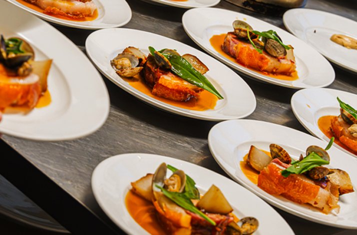 A variety of sablefish, also known as black cod, is served with shellfish and vegetables.