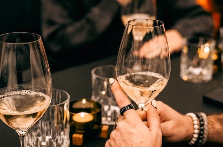 A glass of wine in a woman's hands at The Winery.