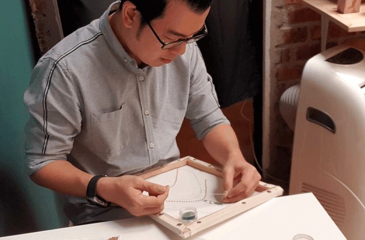 Kenny Loh making custom embroidery.