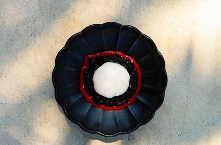 A white plate filled with a colorful assortment of food items made by the Lemongarden Restaurant