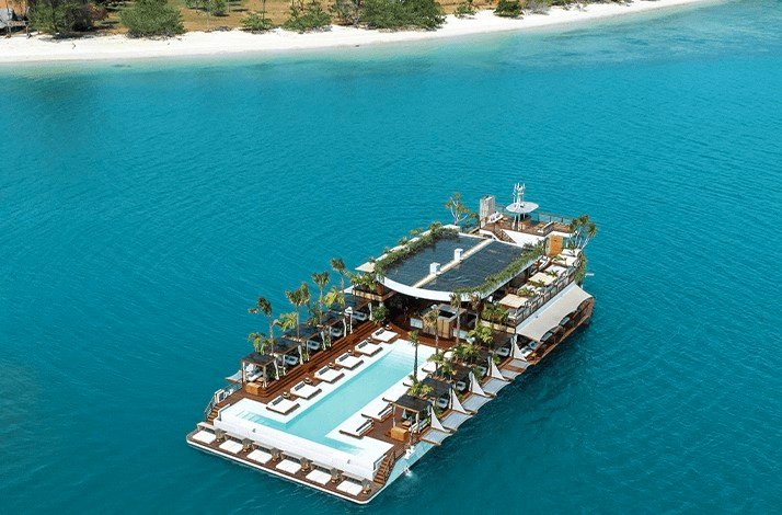 A boat floating in the ocean near YONA Beach Club