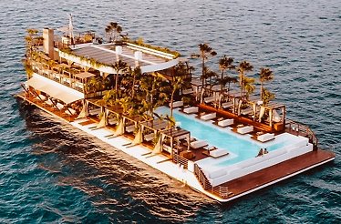 A boat floating in the ocean near YONA Beach Club