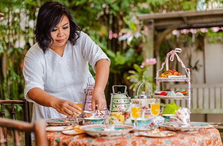Sophia Yeow, a former contestant on MasterChef Singapore, at her home serving the table.