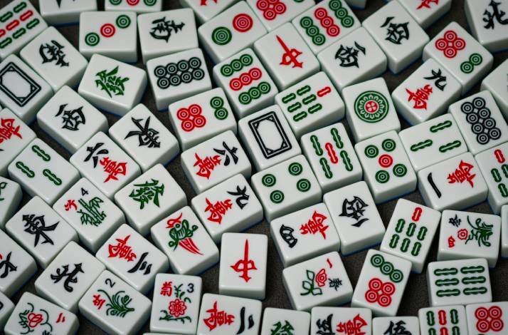 A colorful mix of traditional Mahjong tiles spread out randomly.