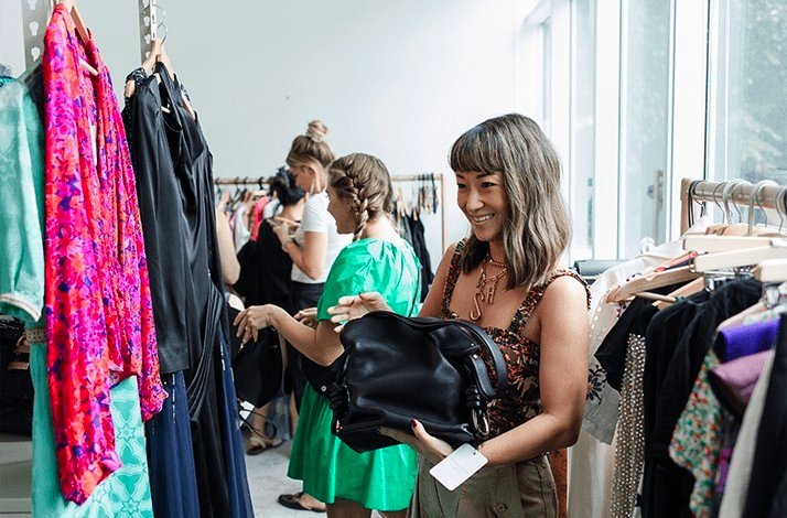 Stylist Sera Murphy looking at a bag in a clothing store