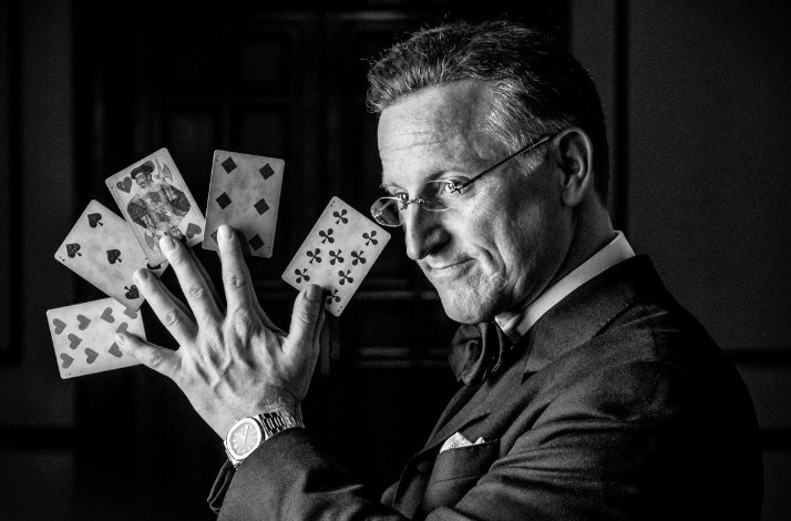 Steve Cohen holding game cards.