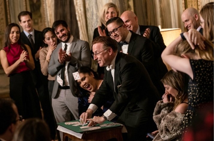 Steve Cohen is making a trick with cards on the show.