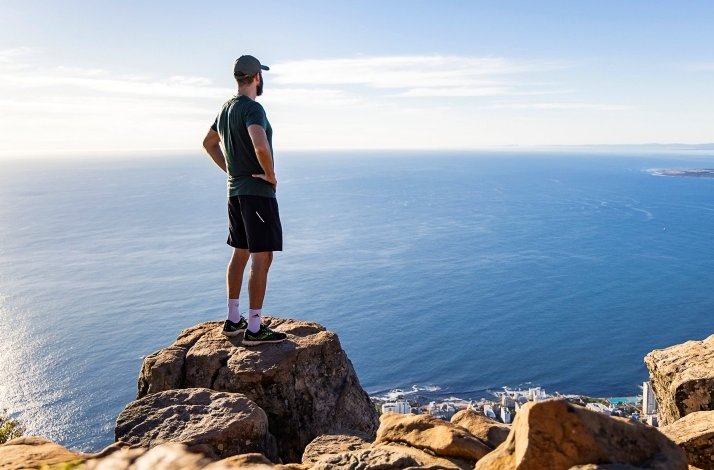 A man standing and overlooking the Lion's Head mountain in Cape Town, South Africa..