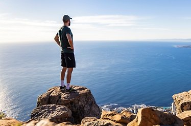 A man standing and overlooking the Lion's Head mountain in Cape Town, South Africa..