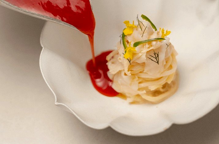 Red yeast rice noodles topped with sauce at ASU.